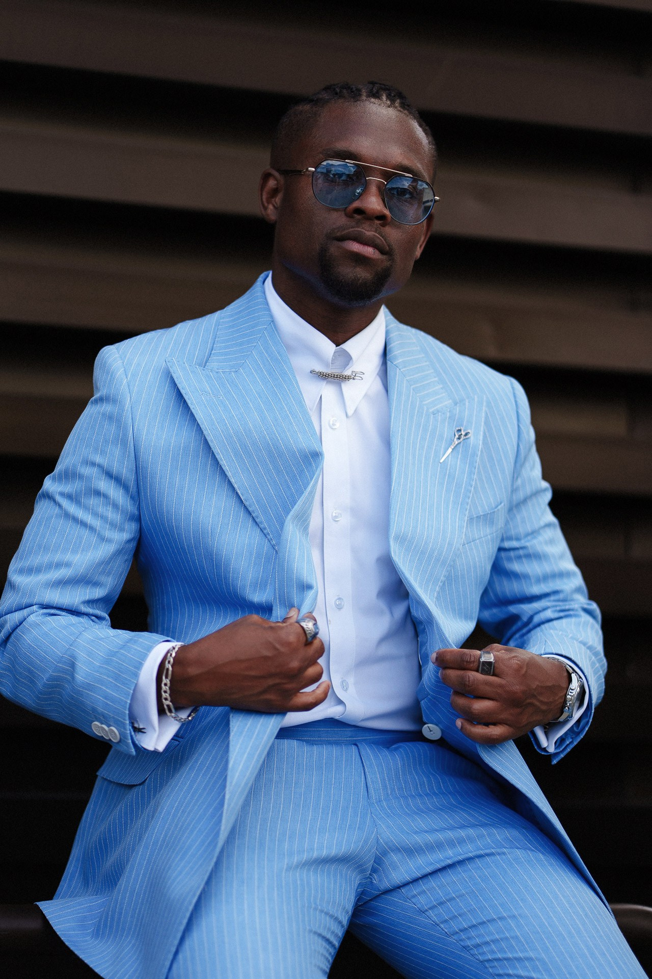 Pitti Uomo 110 street style portrait, guest in light blue pinstripe suit and sunglasses