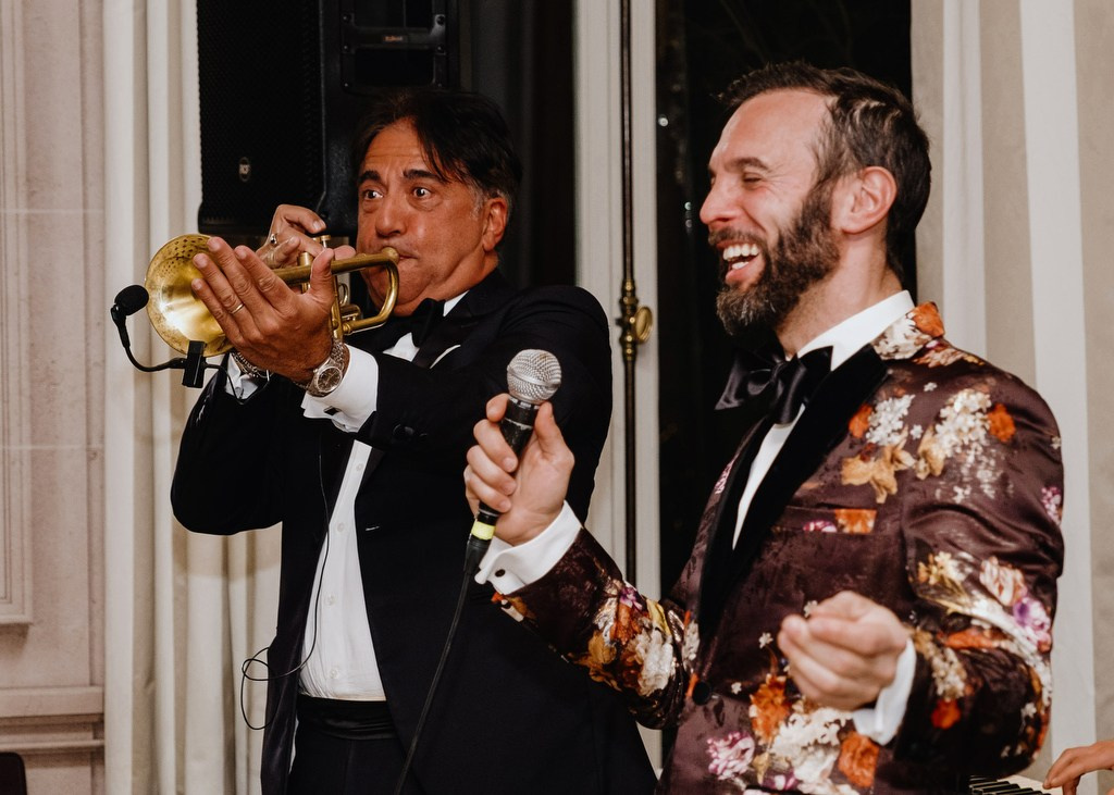 Trumpeter and host performing at a private evening event in Paris