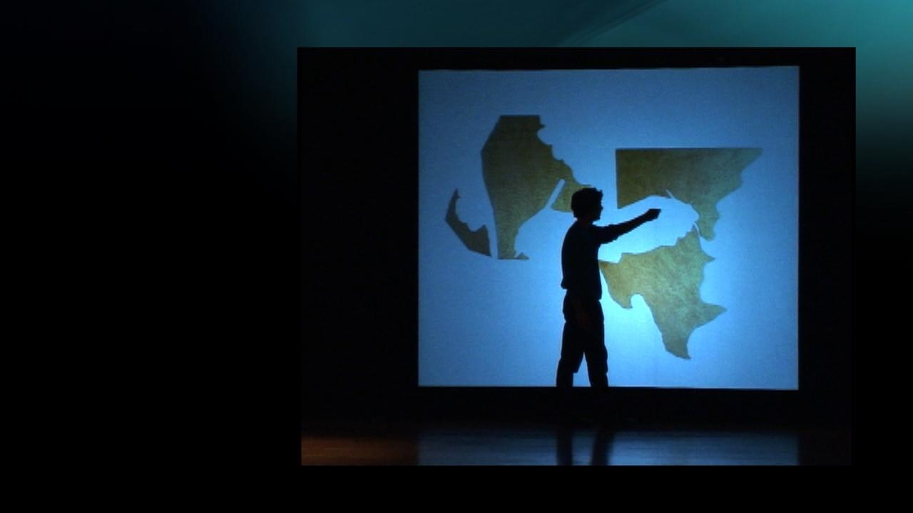 Кадр из видеоинсталляции Сета Прайса «Redistribution» (2007–н.в.), одноканального видео переменной длительности, начатого как лекция в Музее Гуггенхайма в 2007 году, представляет анти-дизайн и цифровой брутализм через фрагментированные повествования, найденные интернет-материалы и грубую эстетику, исследуя влияние цифровых медиа на авторство, культуру и распространение информации. «Redistribution» (2007–н.в.) — работа Сета Прайса (Seth Price, род. 1973, Восточный Иерусалим), американского мультидисциплинарного художника, начатая как лекция в Музее Гуггенхайма в 2007 году. Проект, существующий в нескольких версиях (не менее восьми итераций), представляет собой гибрид лекции, перформанса и эссе-видео в традициях caméra-stylo. Прайс перерабатывает исходную документацию лекции, добавляя новые кадры, включая CGI, найденные интернет-видео (например, сцены из фильма Томаса Эдисона Little Mischief 1898 года) и нарративы, такие как обсуждение видео казни журналиста Дэниела Перла. Работа критикует системы производства и распространения информации, подчёркивая «загрязнение» и «размытие» в цифровой культуре через минималистичную, грубую эстетику, соответствующую анти-дизайну и брутализму. Выставлялась в галереях Petzel, Metrograph (Нью-Йорк), ICA (Лондон) и других пространствах. 