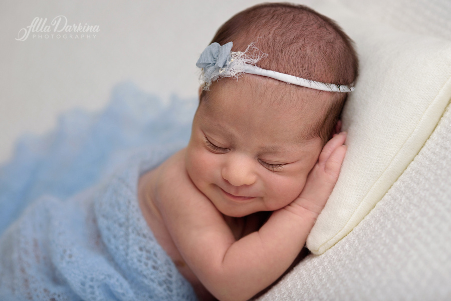 Happy sleeping newborn baby studio session.