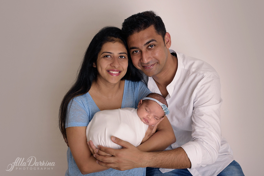 Happy loving family with newborn portrait studio photoshoot in Sydney.
