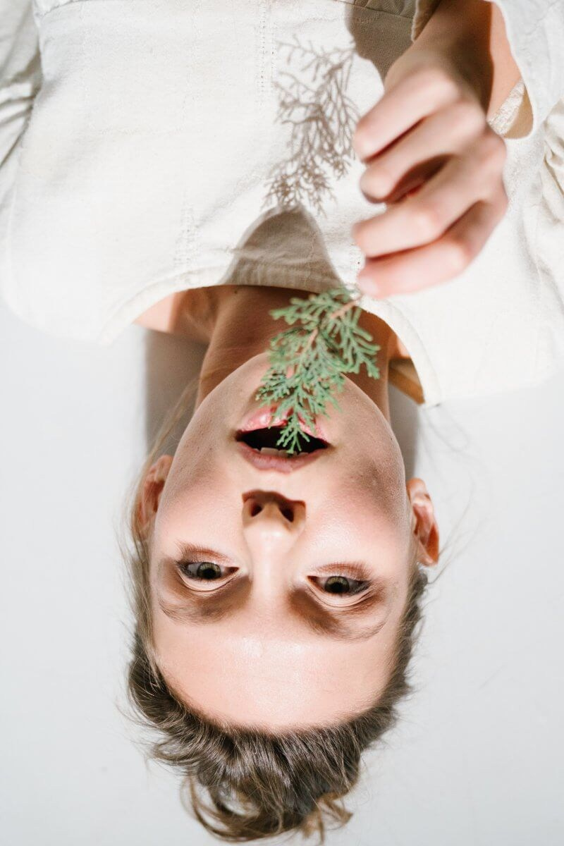 Creative upside down female portrait with woman holding small plant artistic personal photosession Munich