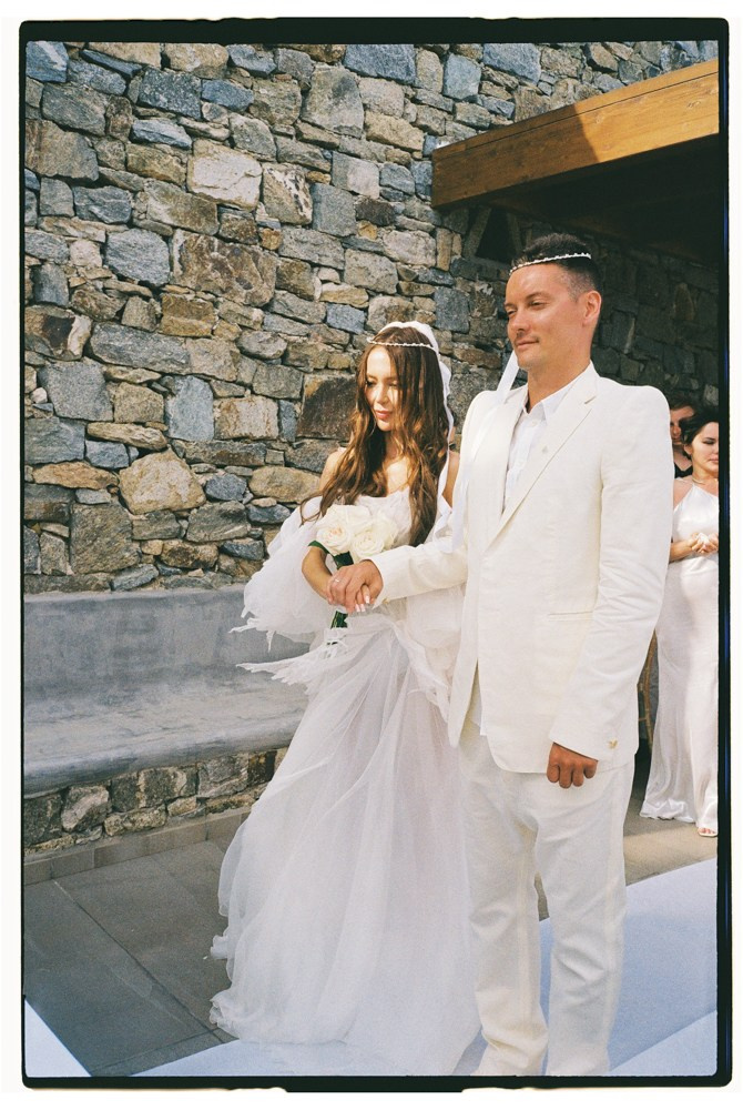 Bride and groom walking during destination wedding ceremony in Mykonos, Greece