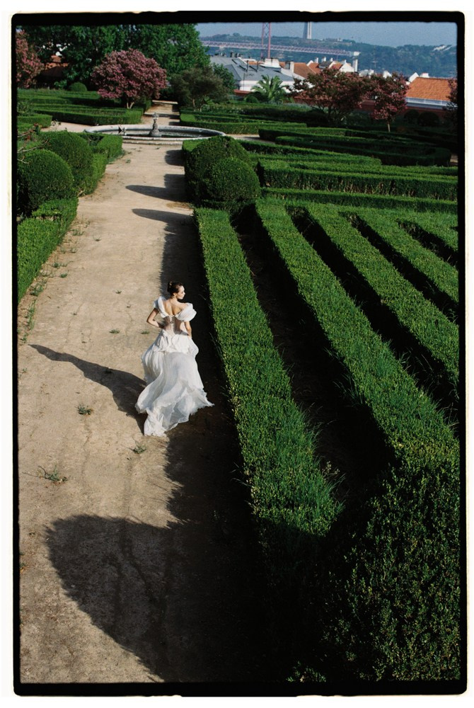 Bride walking through hedges during Portugal destination wedding portraits