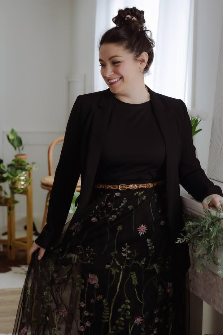 Woman with hair in bun twirling in skirt 