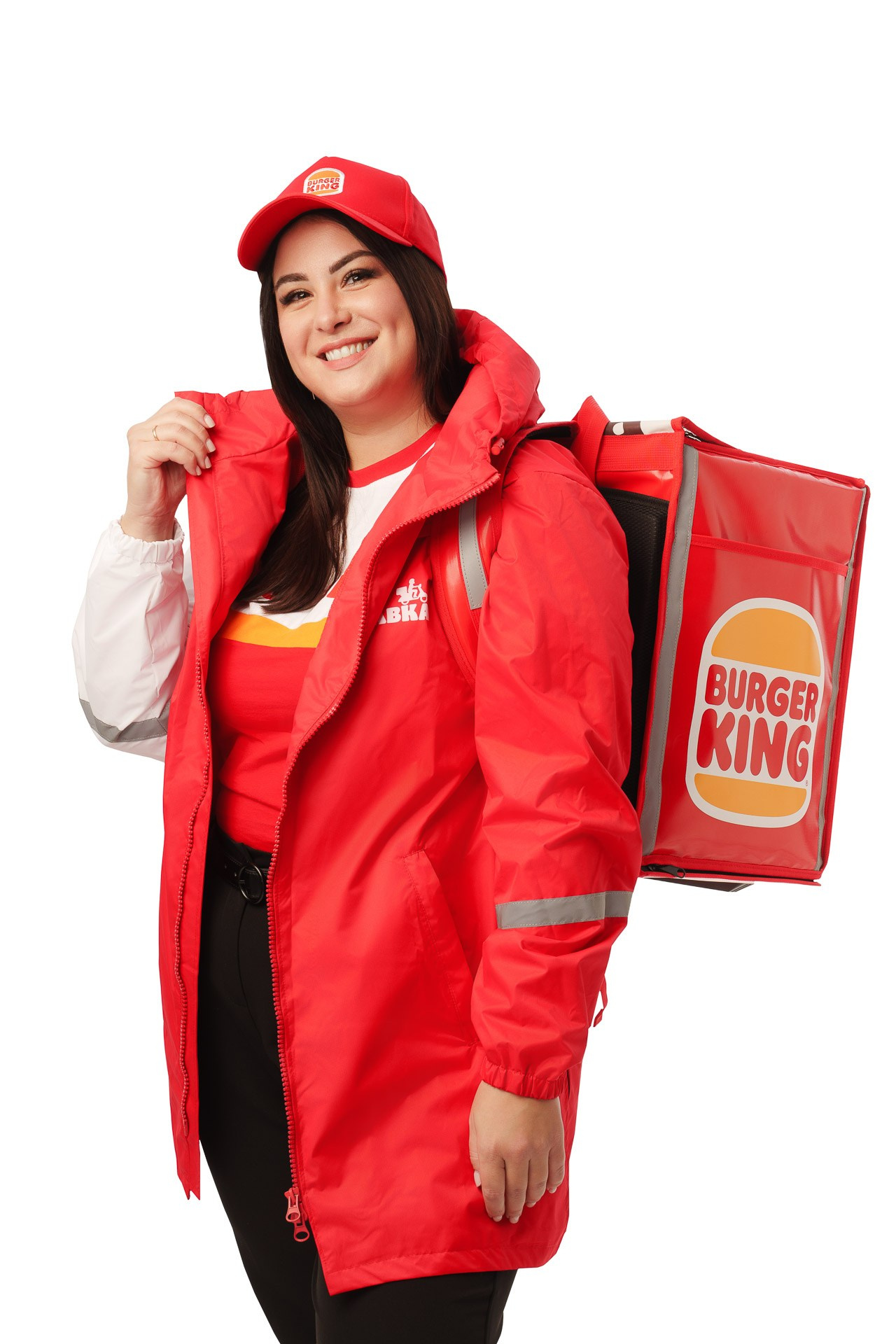 Burger King delivery courier in red jacket with backpack, studio portrait