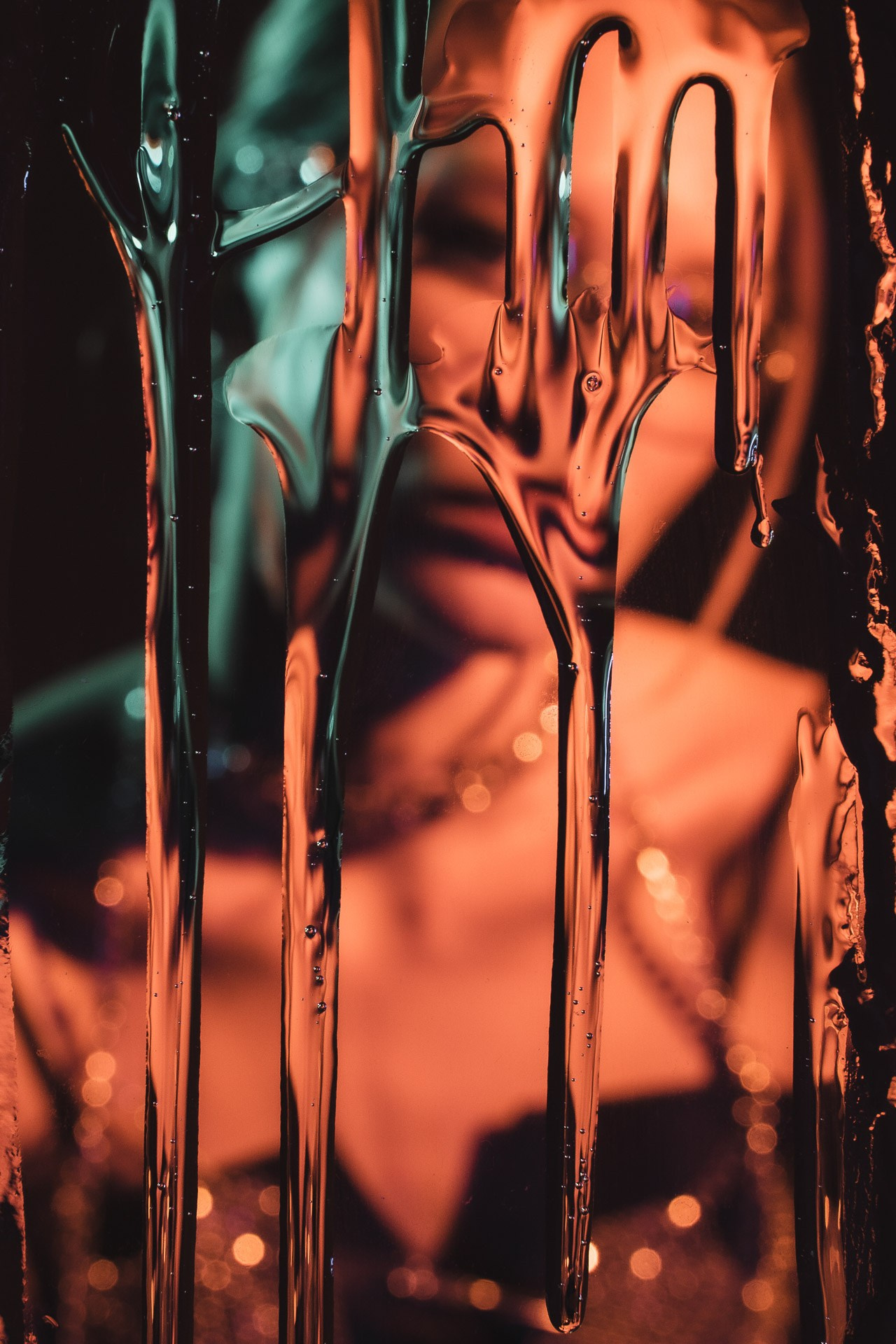 Abstract fashion image with colored liquid texture and reflections, creative editorial photography