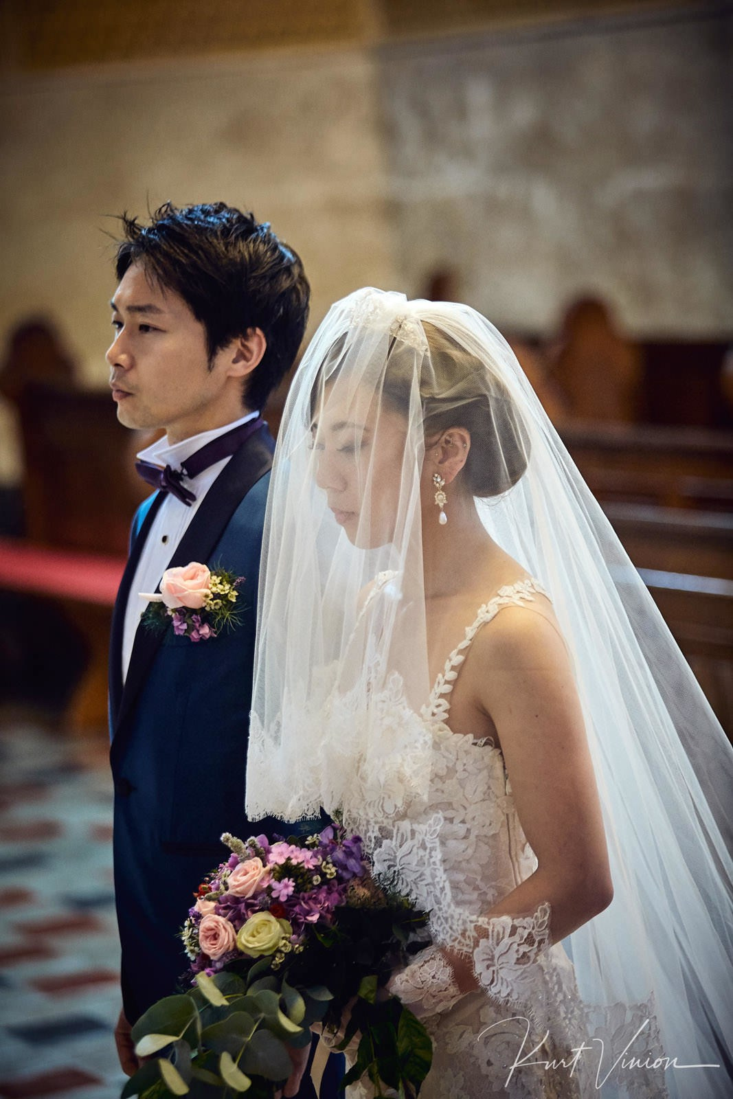 Couple standing attentively at altar St Martin's Church Bled.