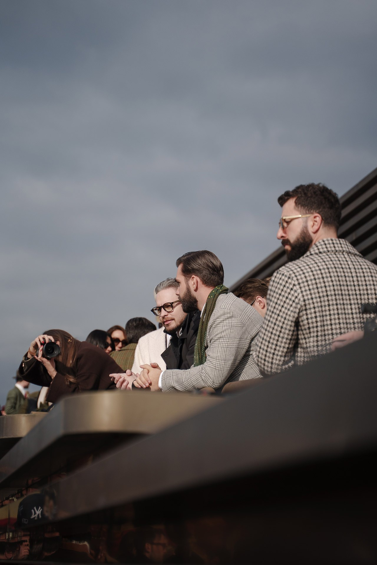 People watching fashion crowd from balcony at Pitti Uomo 109