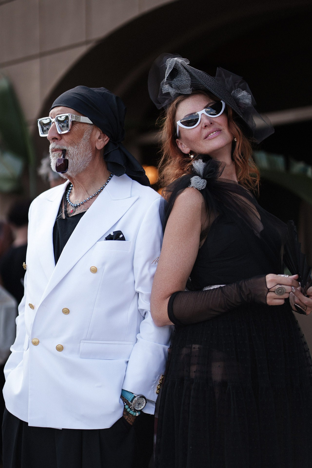 Pitti Uomo 110 street style couple, guests in black and white looks with statement accessories