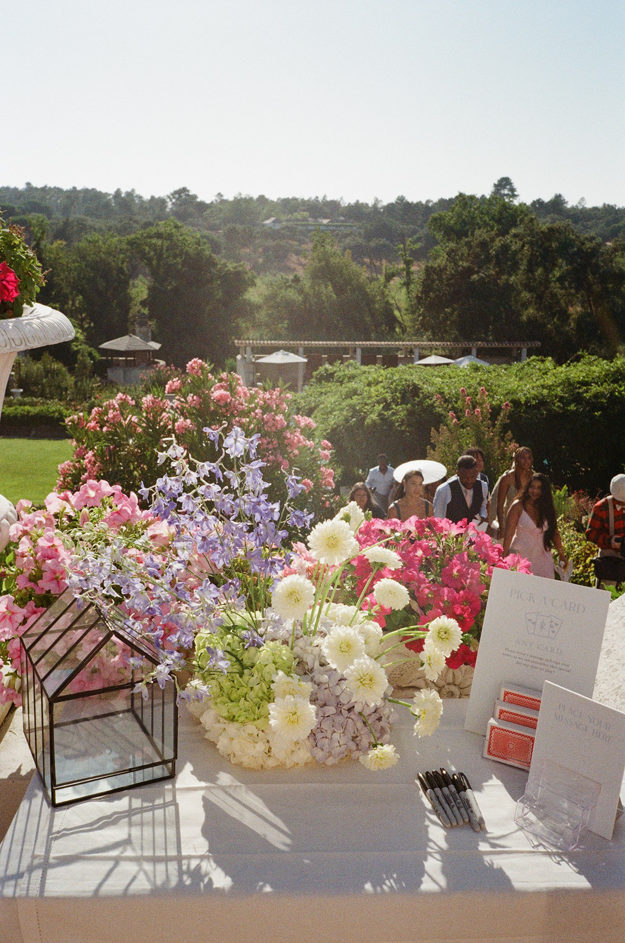Vibrant floral wedding centrepiece with white roses and geometric terrarium, wedding decor by florist O Desejo at Portugal reception