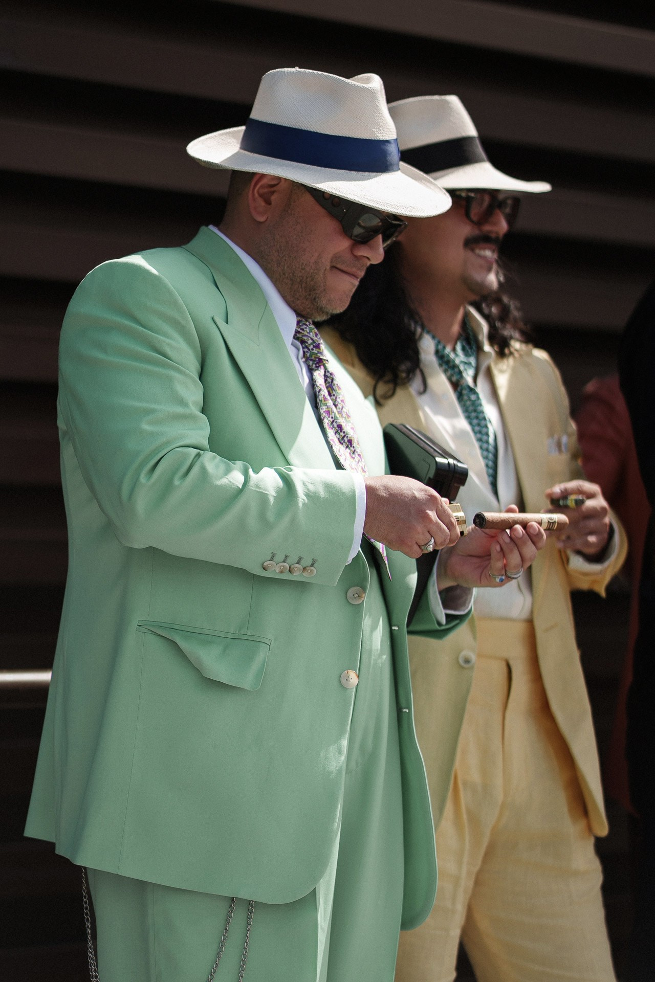 Pitti Uomo 110 street style, guests in mint green and yellow tailored suits with summer hats