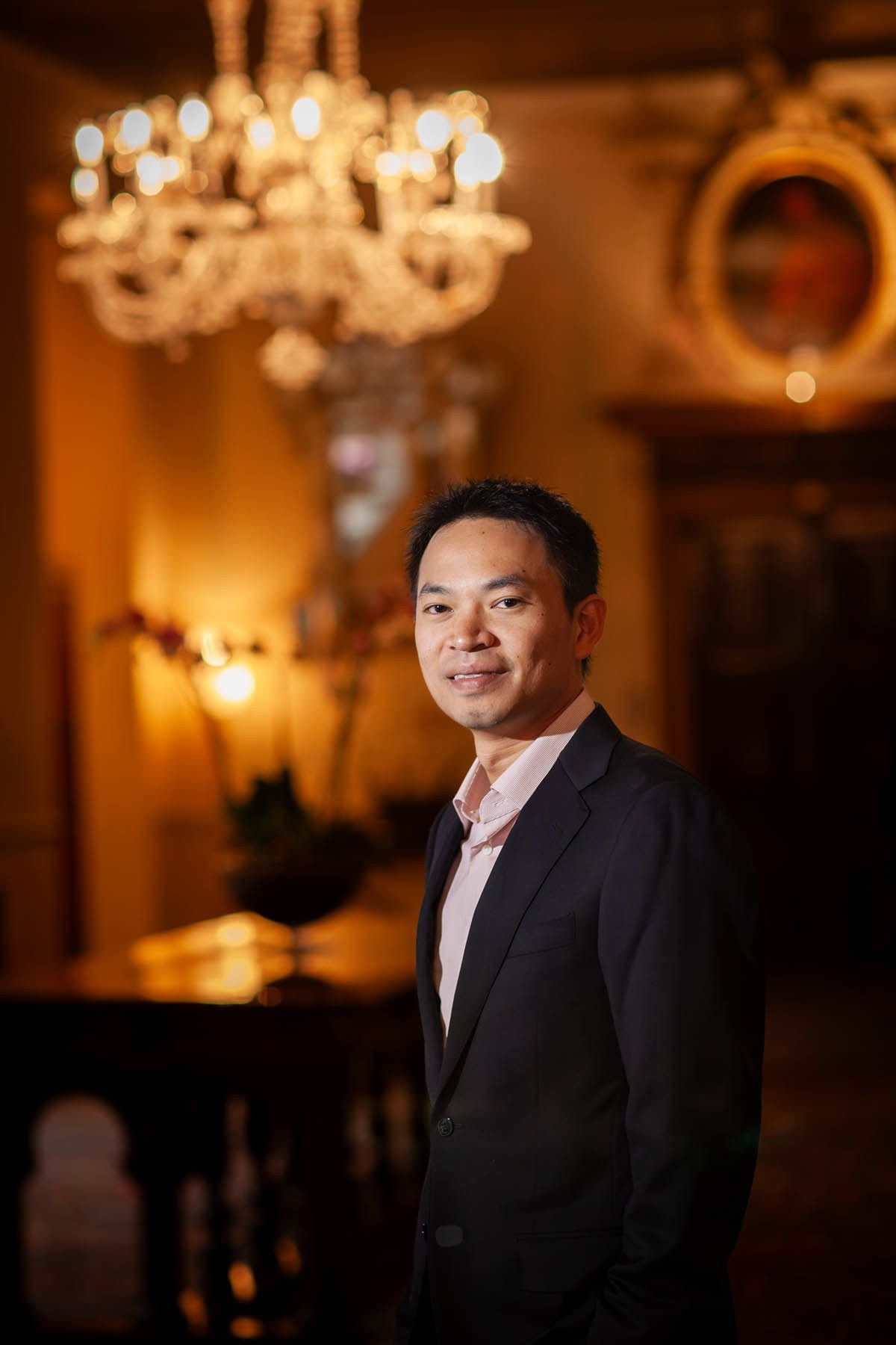 Smiling Thai man portrait inside opulent historic Hotel Danieli Venice.