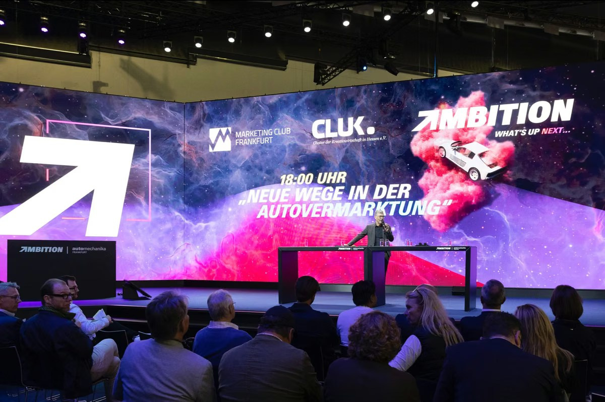 Panel discussion on stage during a collision repair industry event