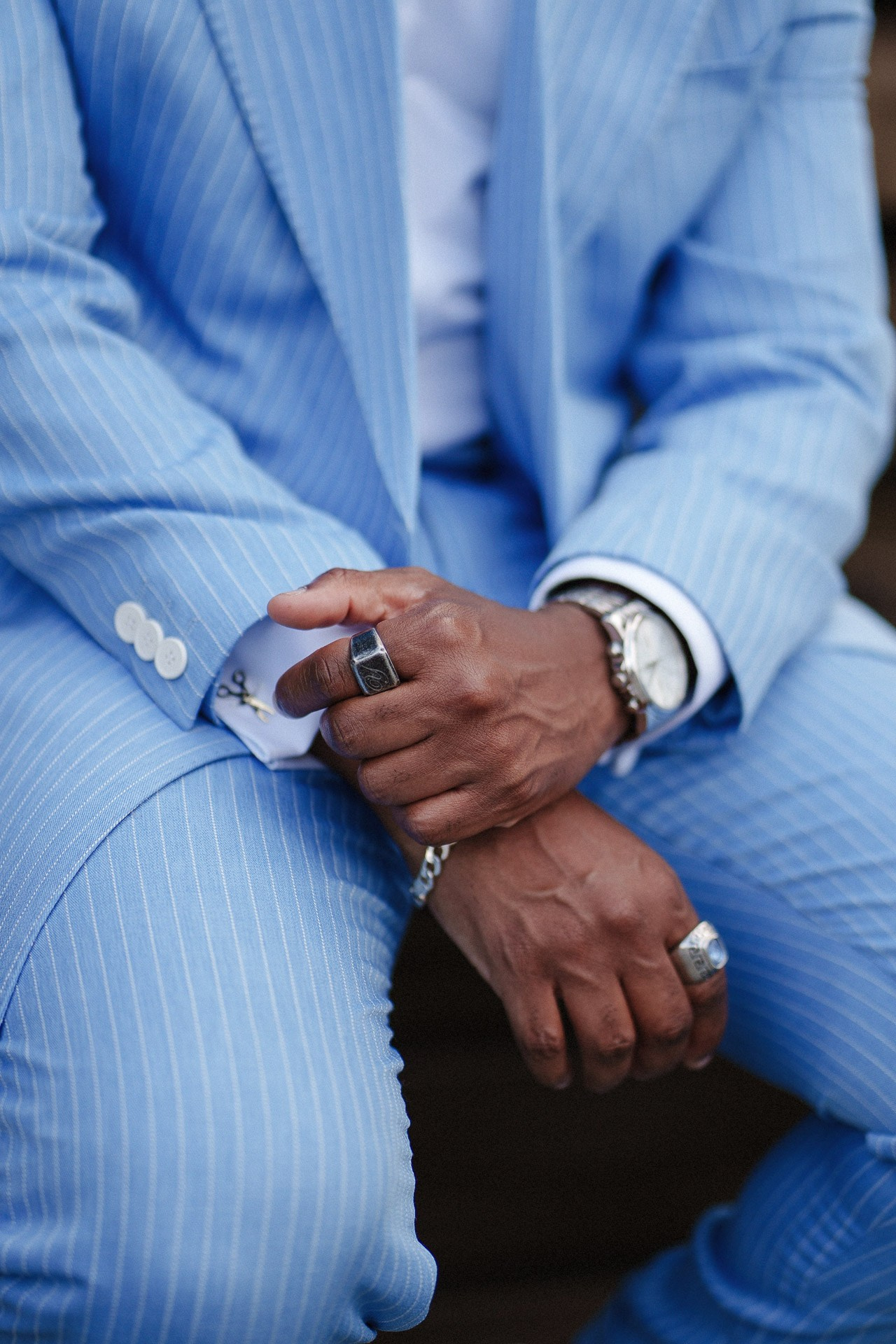 Pitti Uomo 110 detail shot, blue pinstripe suit, rings, watch and menswear accessories