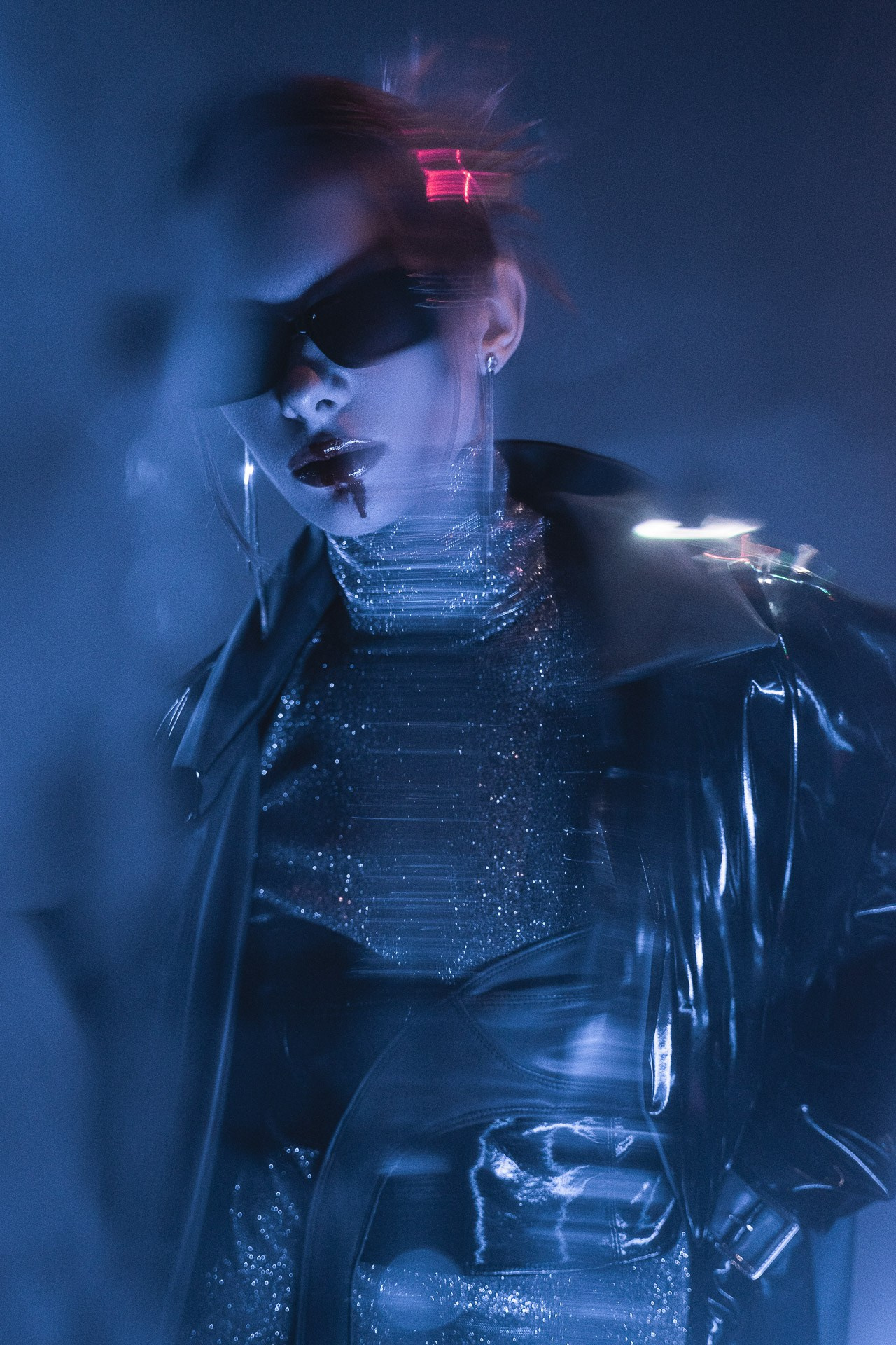 Experimental fashion portrait with neon light and motion blur, Milan
