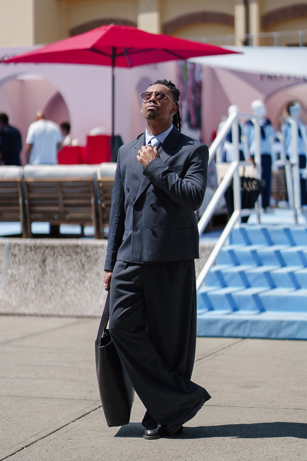Pitti Uomo 110 opening day street style, guest in dark oversized tailoring near the fair