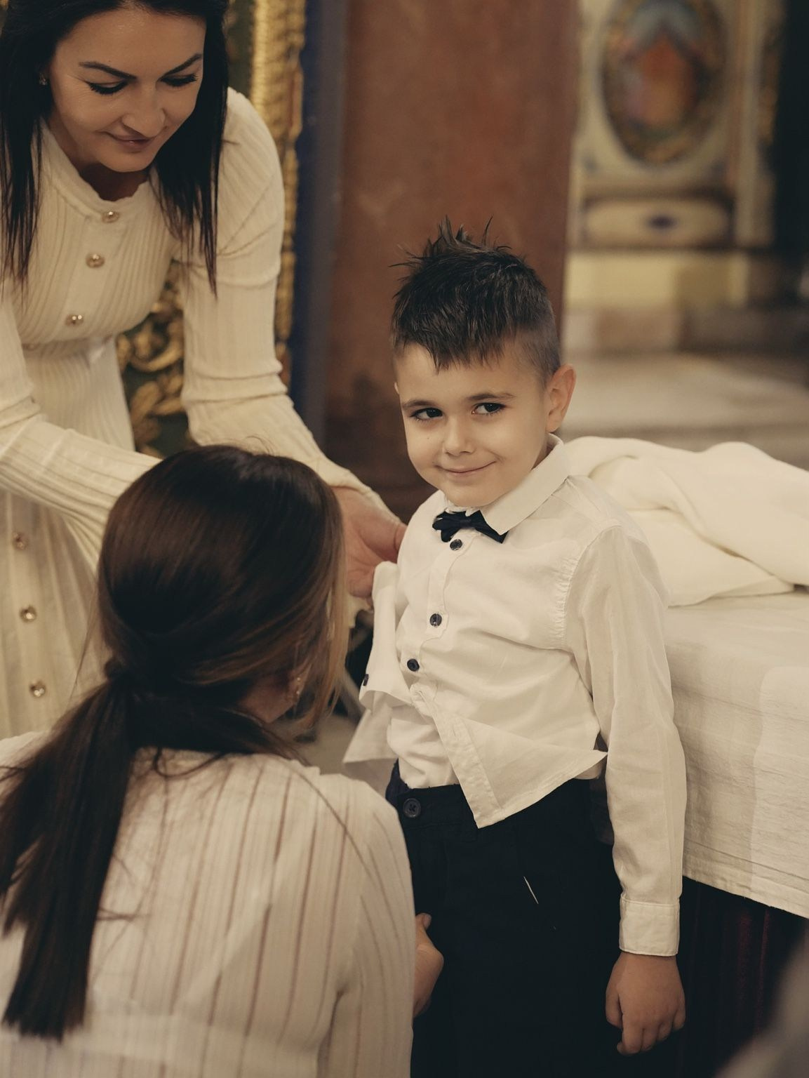 child getting ready for baptism ceremony dressing boy church
