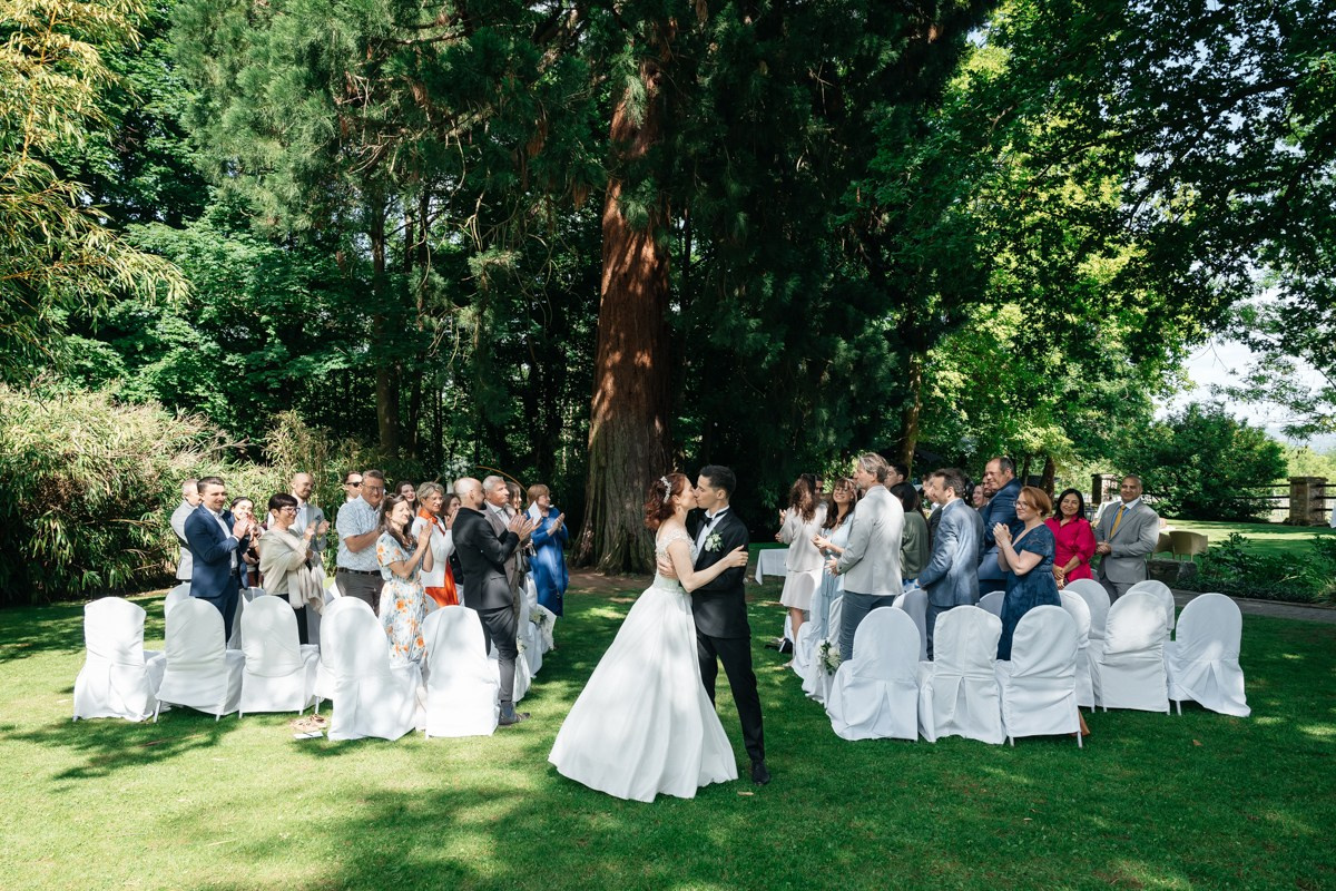 Guests looking at bride and groom after ceremony