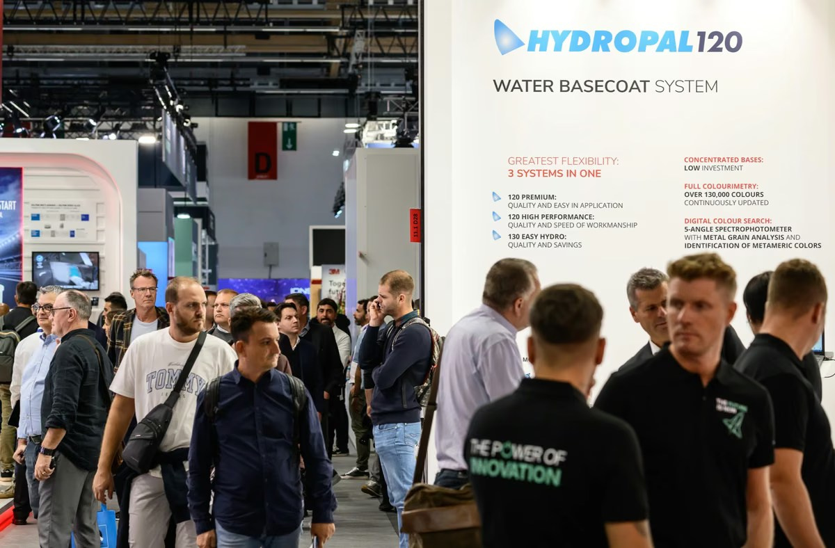 Attendees gathered around a live presentation at a trade show booth