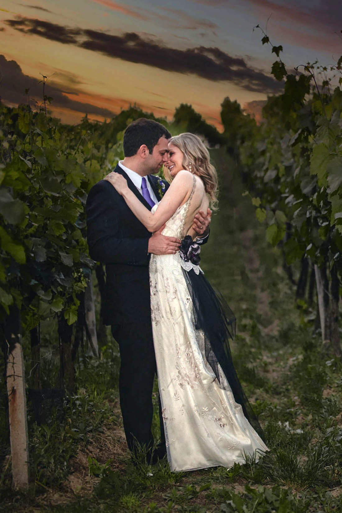 A bride & groom from NYC embrace in her family's ancestral vineyards as the sun sets on her wedding day in Moravia. 