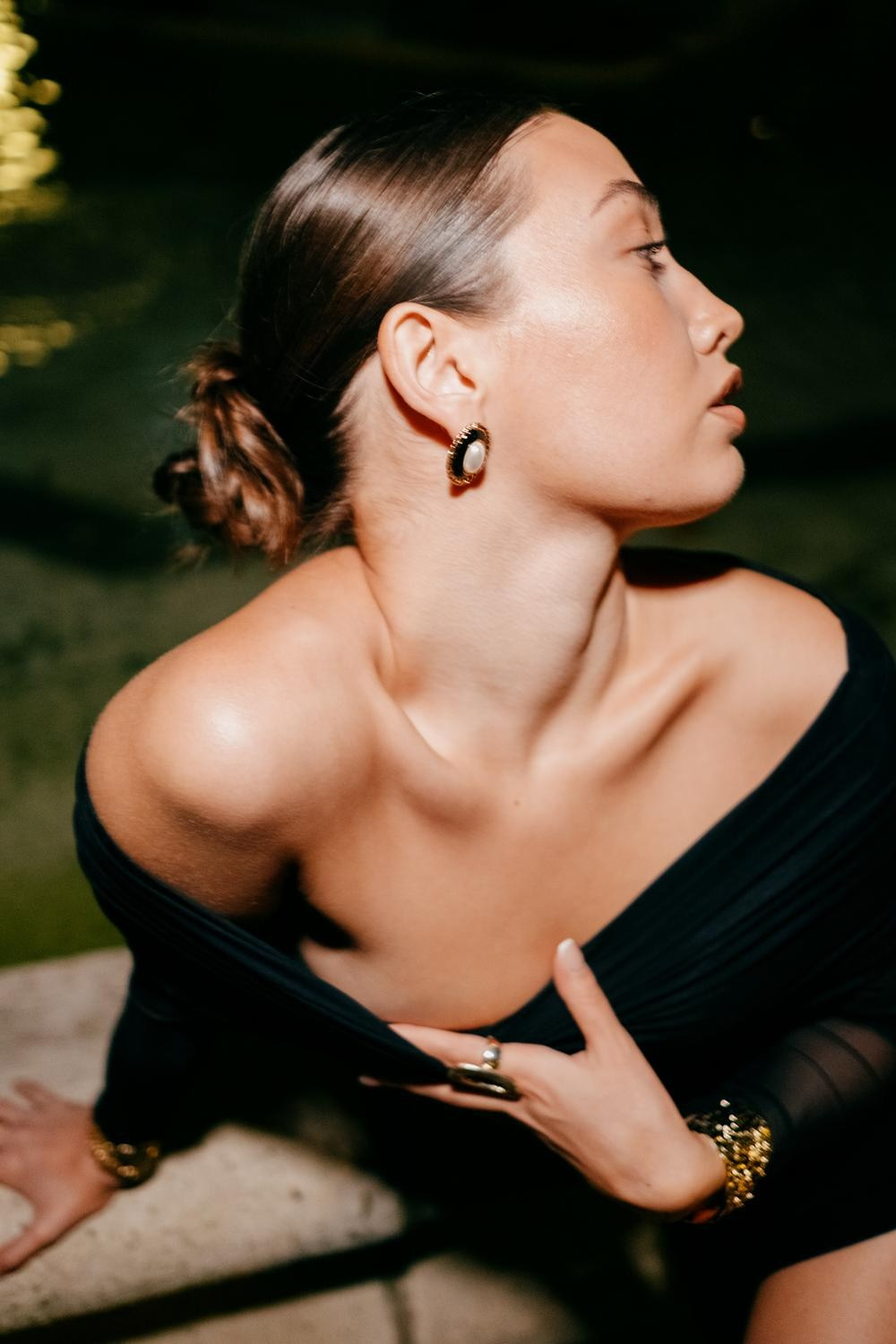 Luxury jewelry commercial shoot featuring an elegant off-the-shoulder black top
