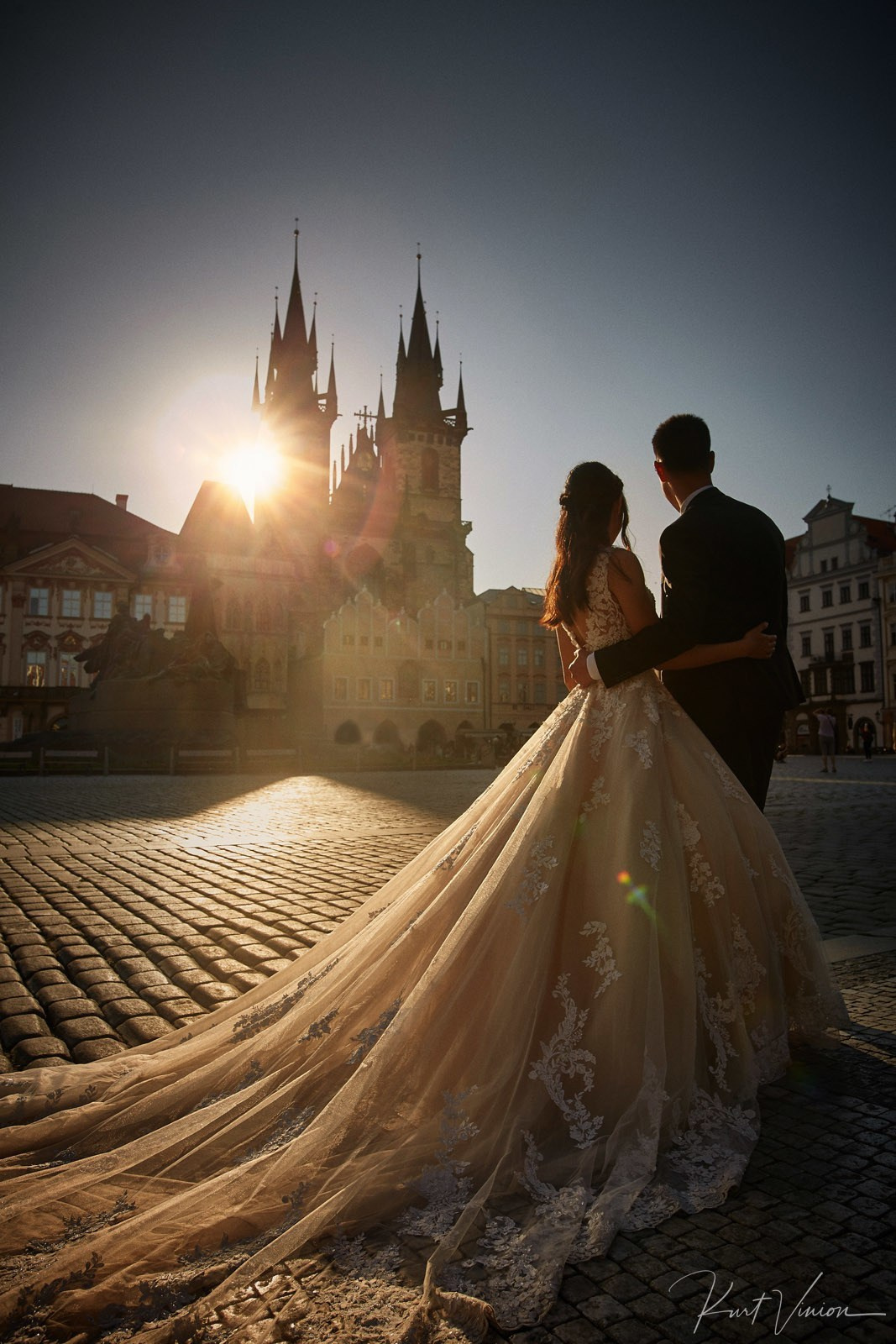 Couple sun flare Tyn Church Old Town Square Prague dawn