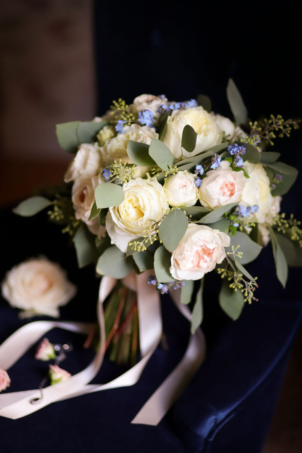 Bridal bouquet with white roses and seasonal flowers on the wedding day