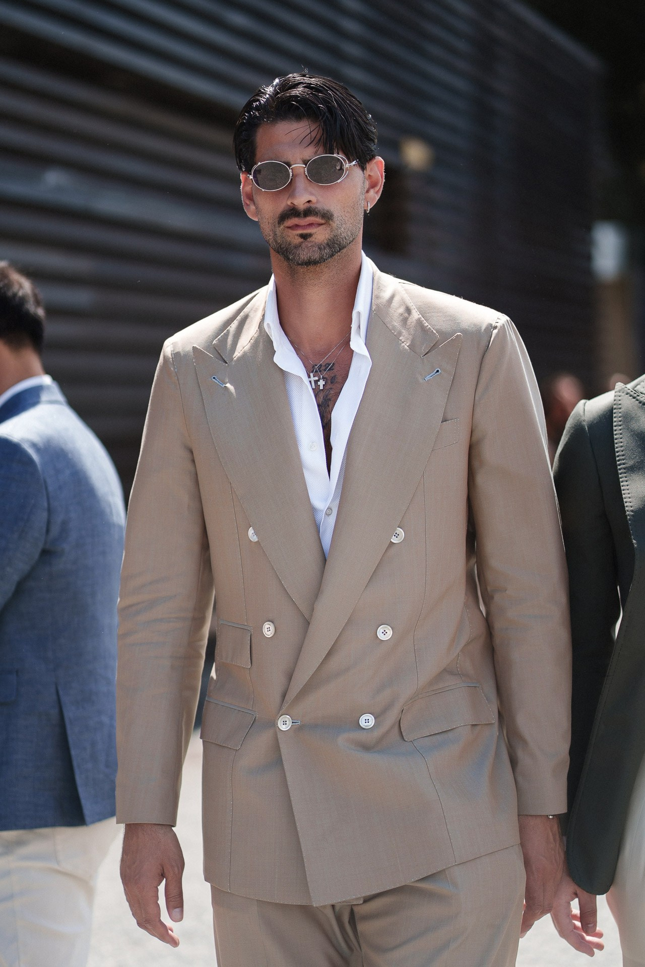 Street style portrait from Pitti Uomo 110, man in beige double-breasted suit and round sunglasses