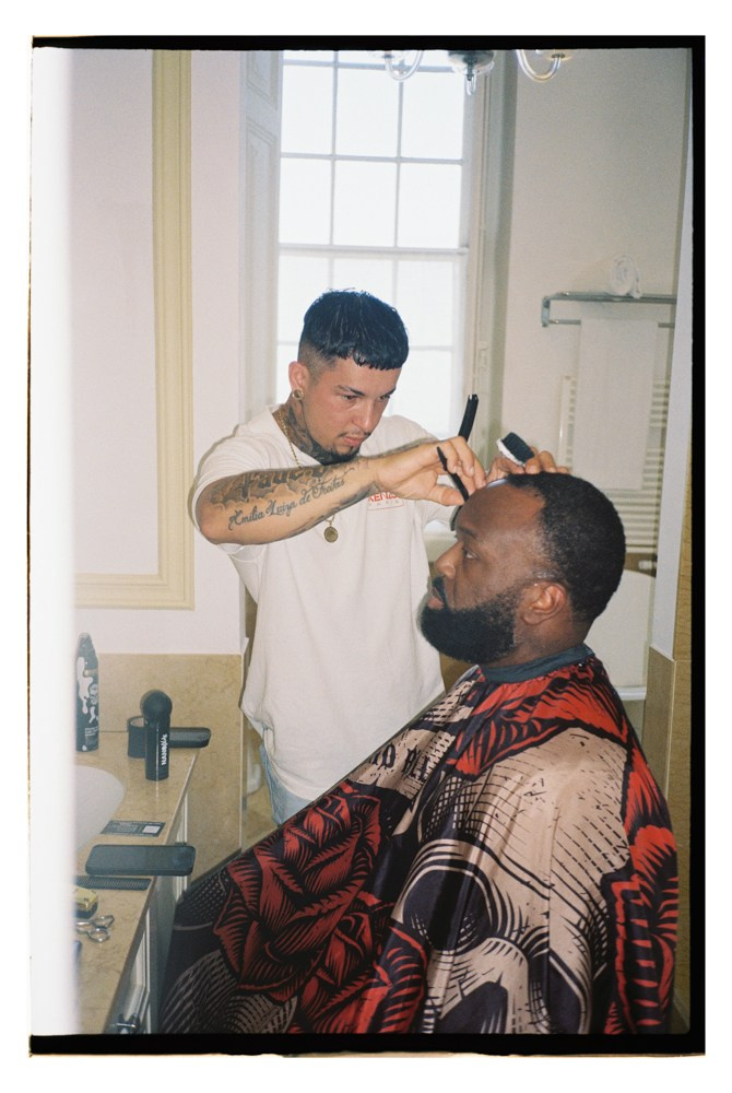 Groom getting haircut during Nigerian wedding preparation in Portugal