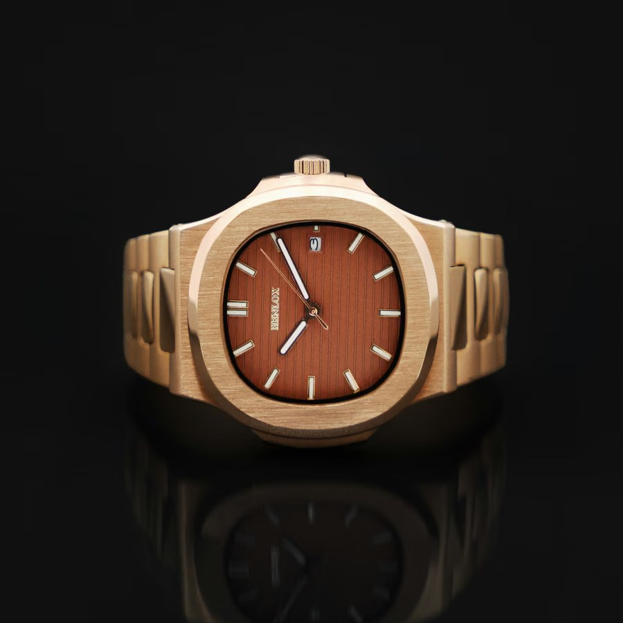 Gold wristwatch with a brown dial on a black reflective background
