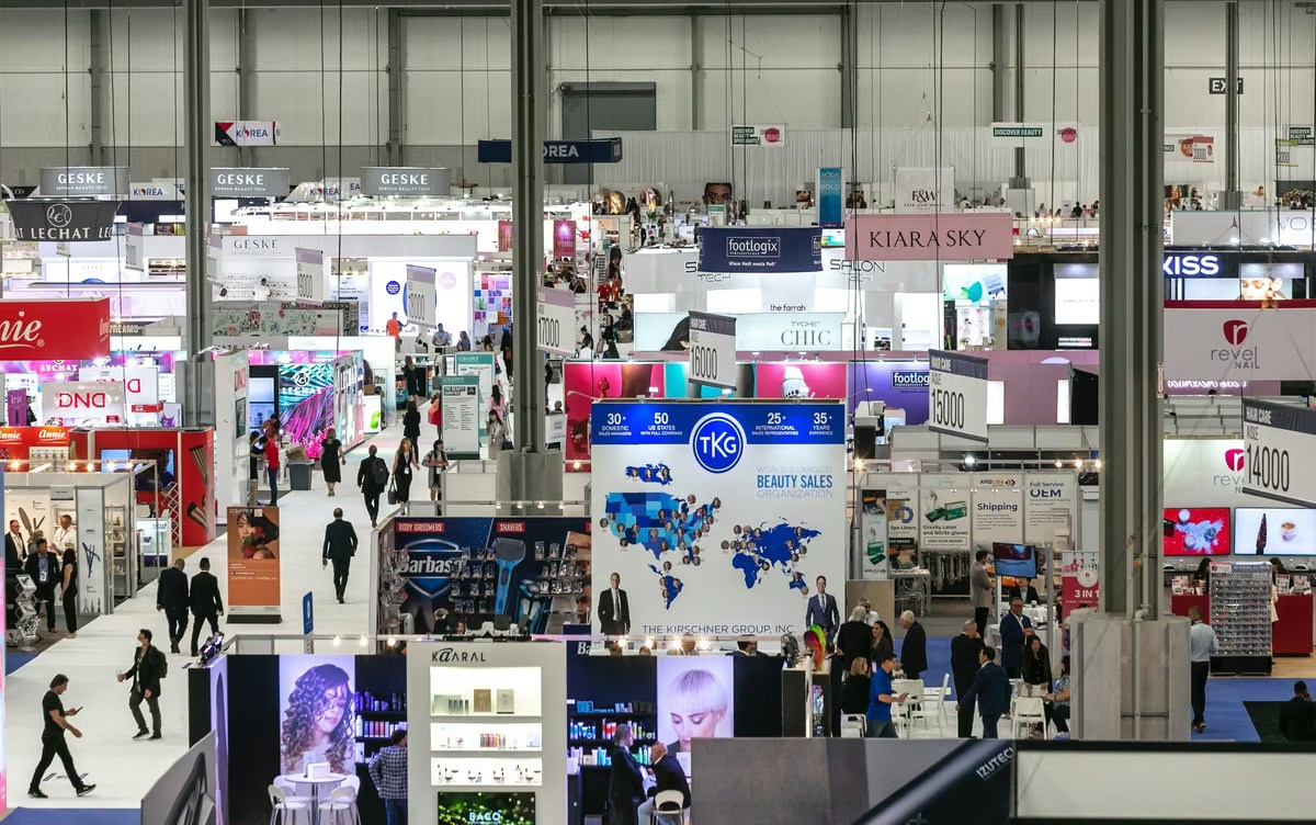 Aerial view of a Dubai trade exhibition floor with branded booths