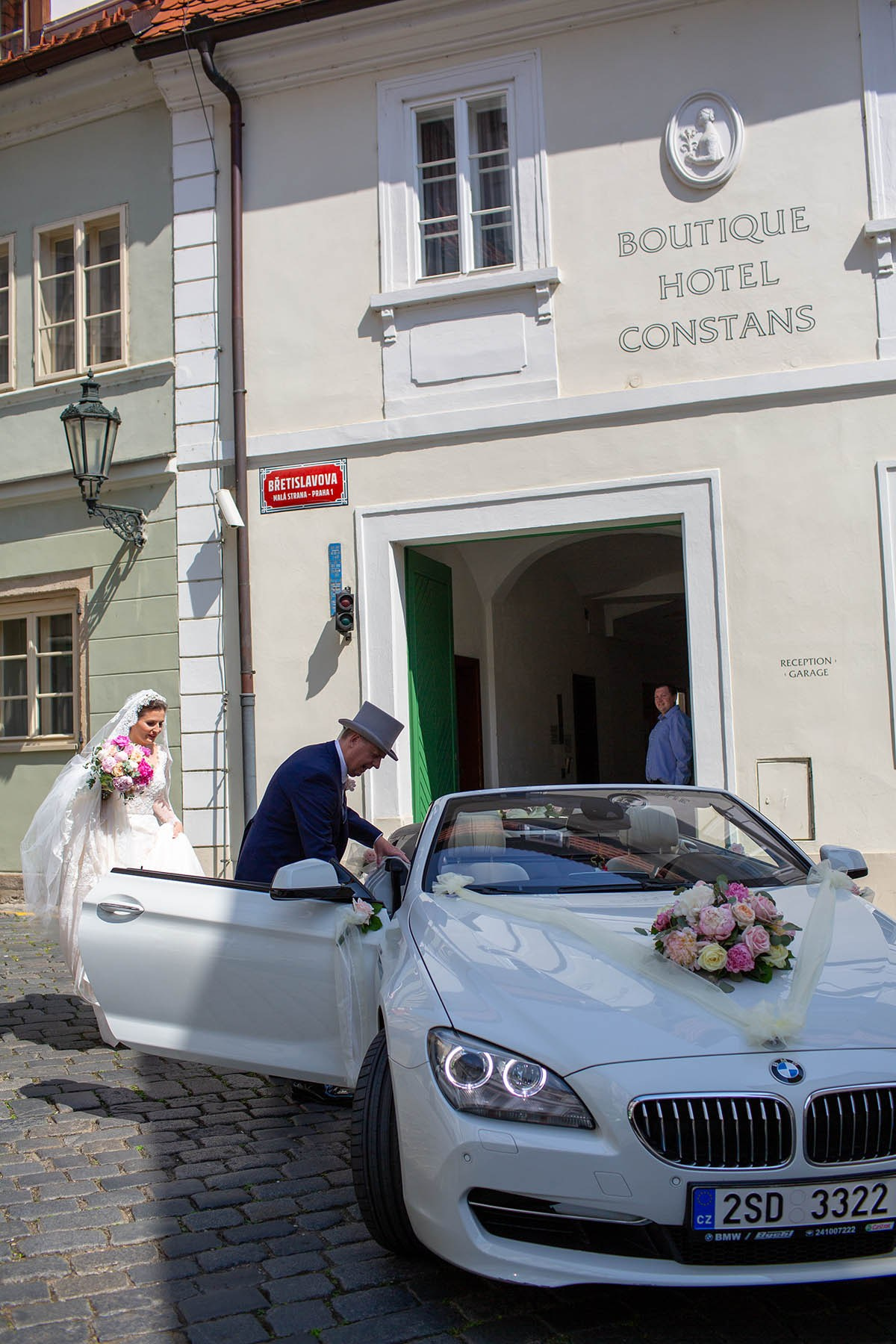 The father of the bride escorts his daughter to their car.