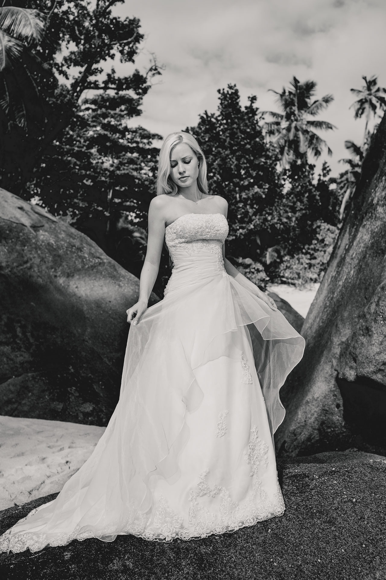 bride posing among the rocks of Seychelles