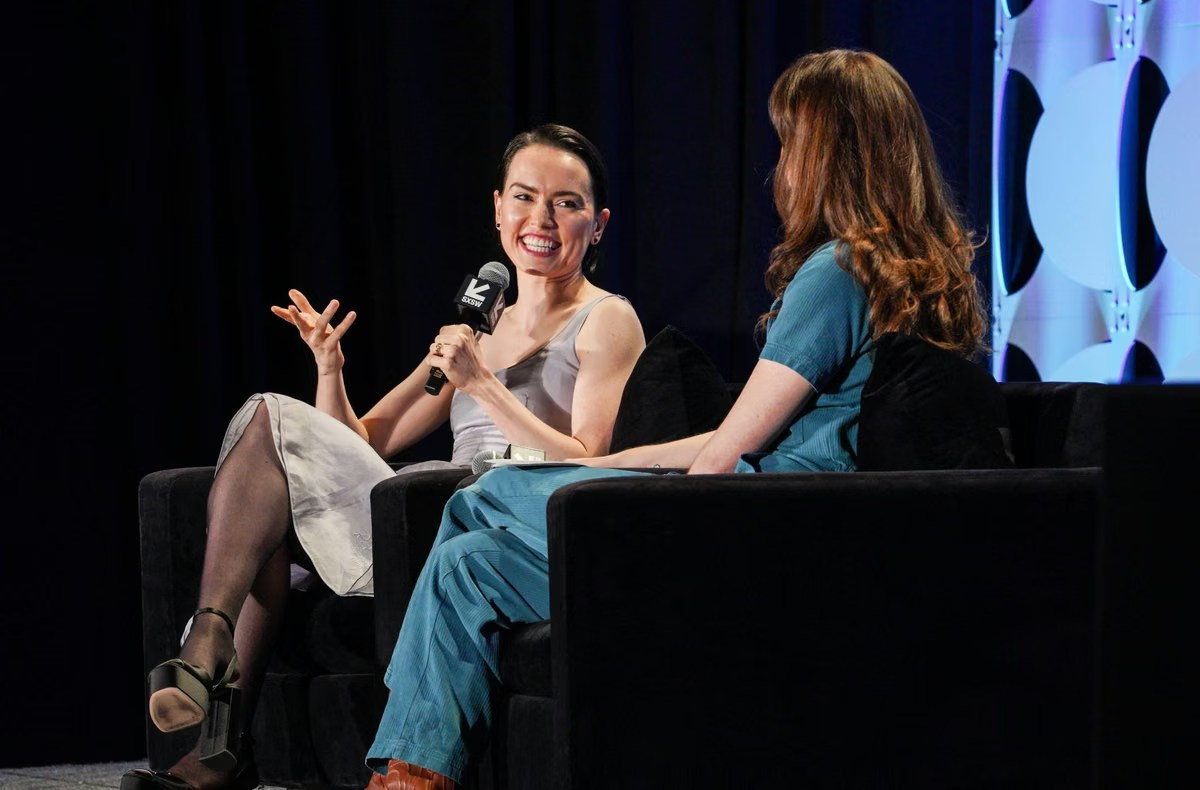 Two female panelists in conversation during a corporate event