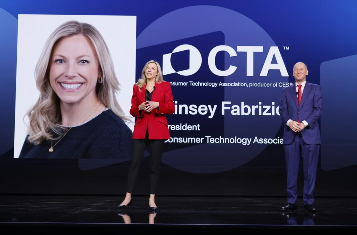 Female presenter speaking on stage at a corporate conference
