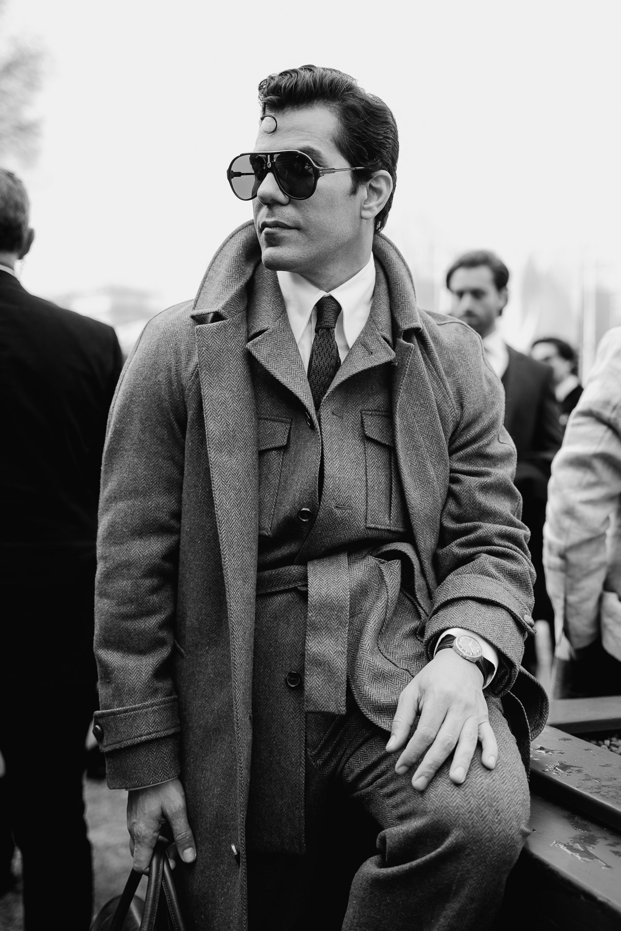 Black and white portrait of man in classic coat at Pitti Uomo Florence