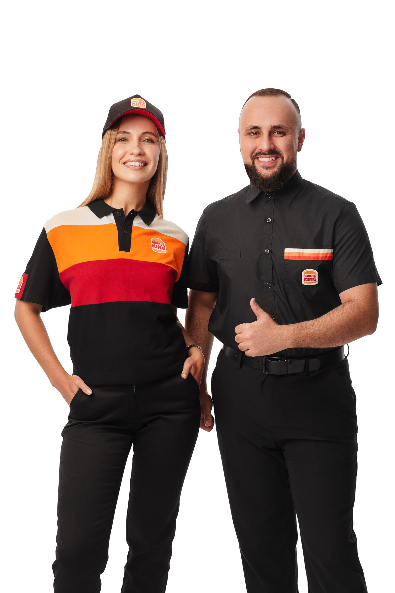 Two Burger King employees posing together in uniform, studio portrait
