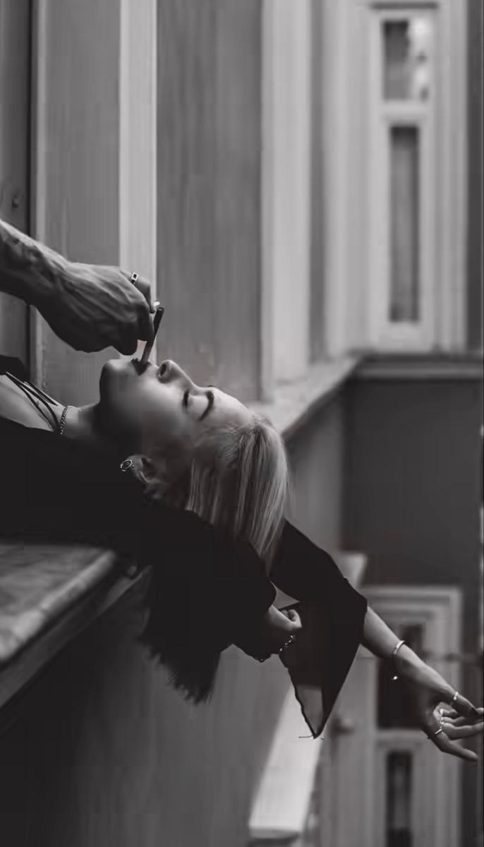 Model Leaning Out the Window with a Cigarette – Intimate Urban Photography