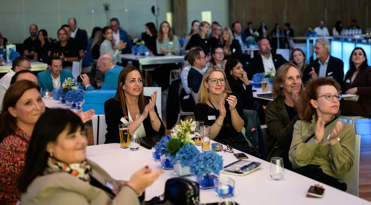Corporate gala audience applauding during an evening event