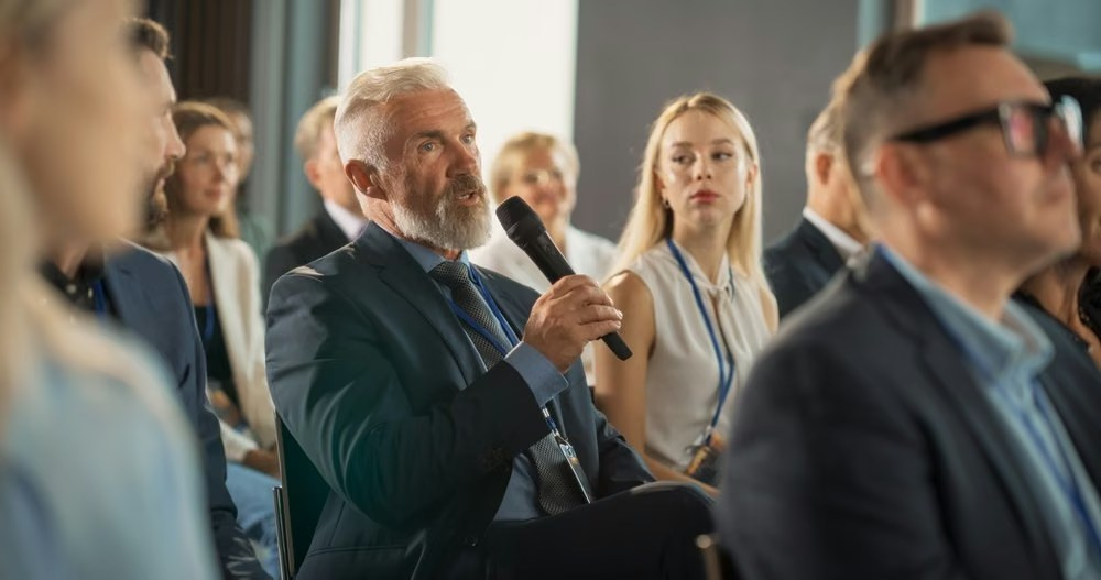 Engaged conference guests listening closely during a panel discussion