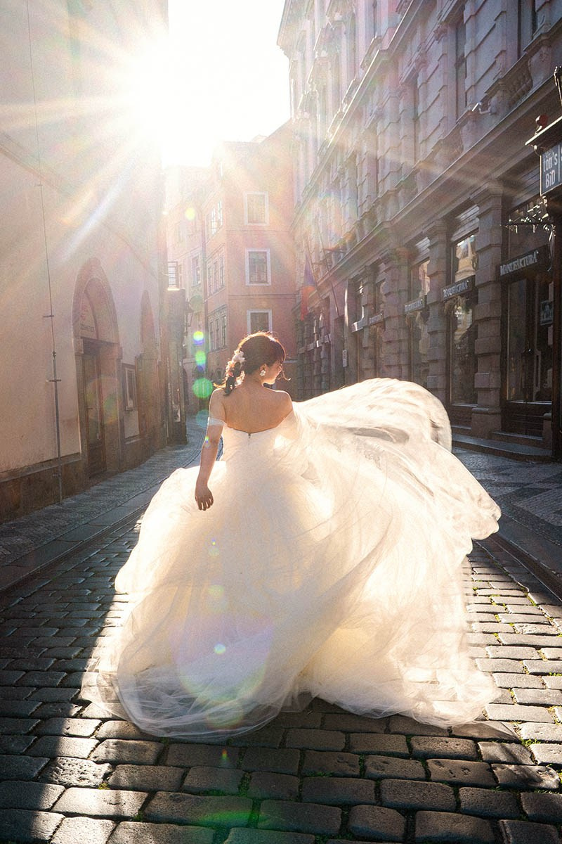 Asian bride with sunrise lens flare during pre-wedding, Prague