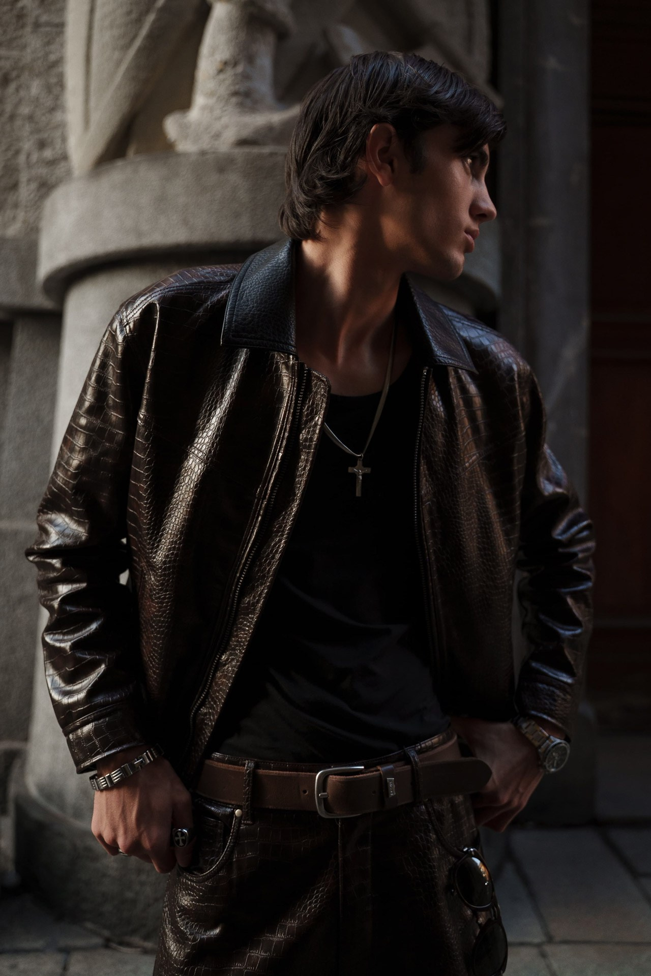 Male model in dark leather jacket during fashion test shoot in Milan