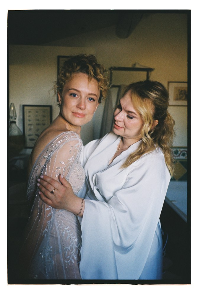 Bride embraced during wedding preparation indoors in Provence, France