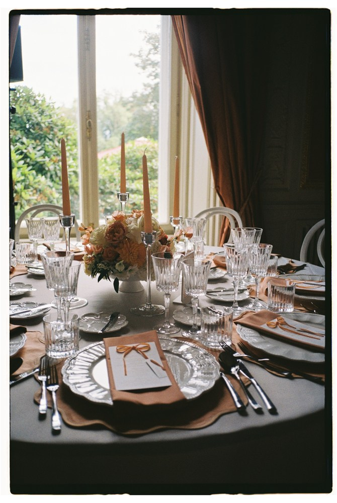 Close up reception table with floral centerpiece and stationery