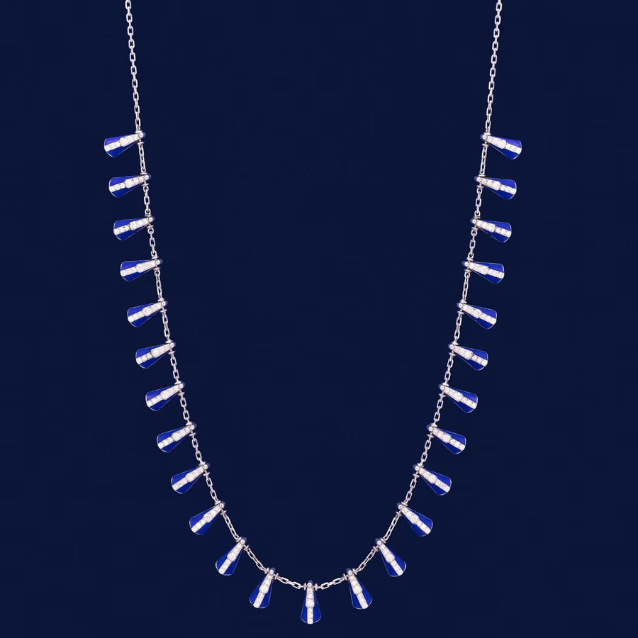 Silver geometric necklace displayed on a dark blue background