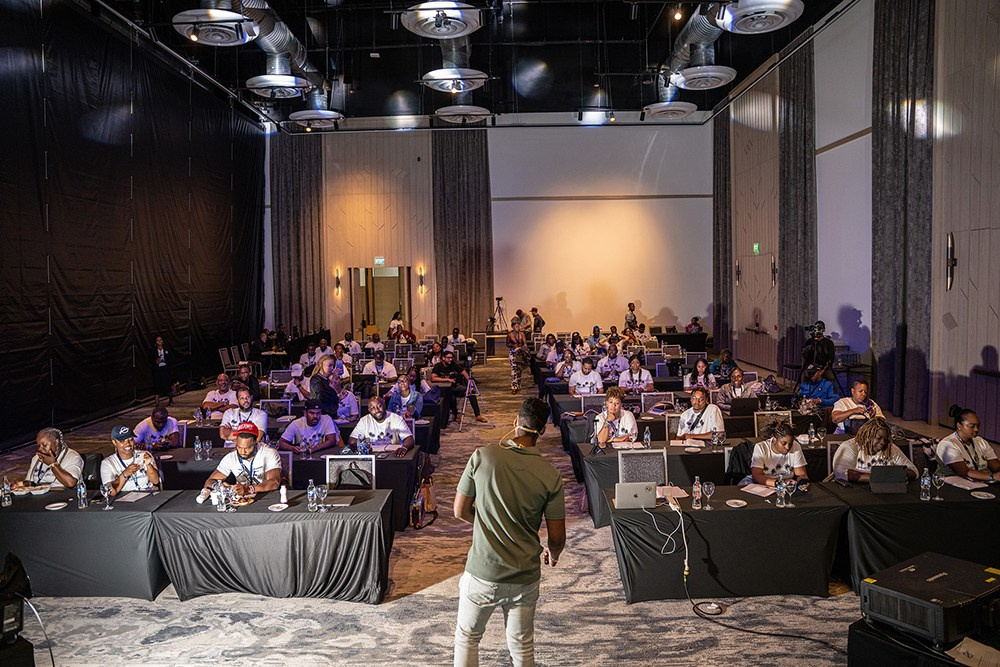 Presenter explaining key points with focused attendees watching.