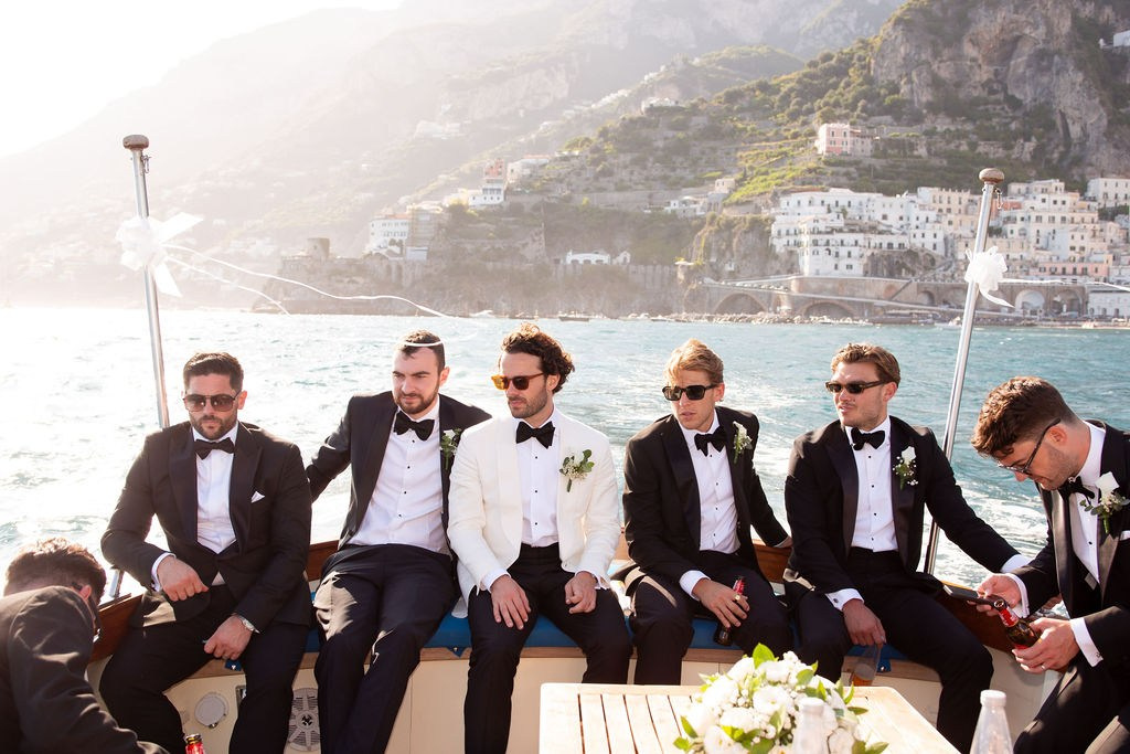 Groom and groomsmen aboard a yacht during a luxury destination wedding in Italy