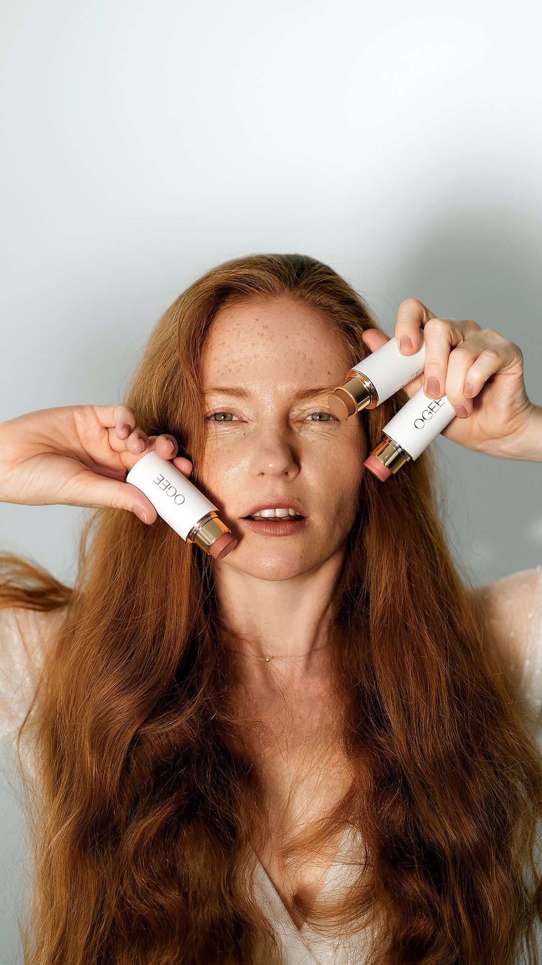 Woman with striking makeup, featuring bold colors that accentuate her eyes and lips. Her hair is styled to complement her makeup, creating a cohesive and dramatic look. The photograph captures the confidence and allure of high-fashion beauty, emphasizing the power of makeup to transform and enhance.