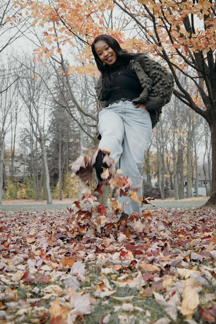 Playful family moment among autumn leaves during a Calgary fall photo session